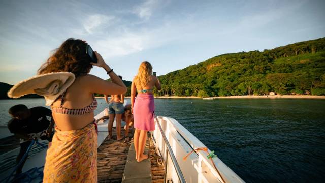 Travellers on board the Big Dream Boatman expedition boat between the islands of Palawan